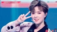 a woman giving a peace sign with a smiley face on her sleeve