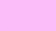 a man with glasses is sitting in a chair with pink bubbles around him .