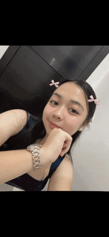 a girl with a watch on her wrist is smiling for the camera