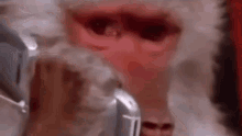 a close up of santa claus ' face with smoke coming out of it .