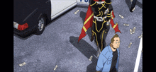 a man in a blue shirt is standing next to a man in a black and gold superhero costume