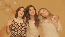three women are posing for a picture and laughing together