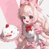 a girl in a pink dress is holding a cake with strawberries on top .