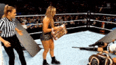 a woman in a wrestling ring holding a roll of money in the bank
