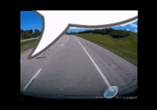 a car is driving down a highway with a speech bubble in the foreground