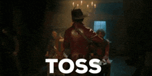 a man in a cowboy hat is dancing in front of a sign that says " the sauceee "
