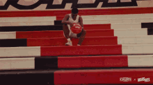 a basketball player is sitting on a set of bleachers with the name pollard written above him