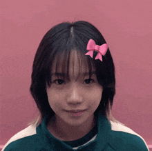 a young girl with a pink bow in her hair