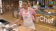 a woman wearing an apron that says delfina