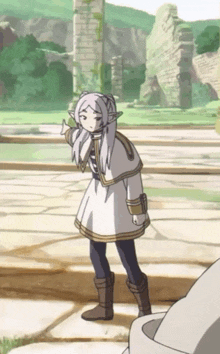a cartoon character with white hair is standing in front of a stone wall