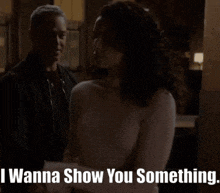 a man and a woman are standing next to each other and the woman says i wanna show you something