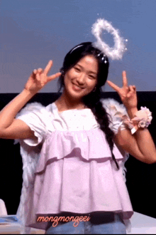 a girl wearing angel wings and a halo with mongmongeei written on her top