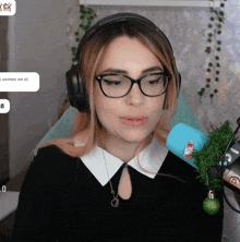 a woman wearing glasses and headphones has a sticker on her ear that says " vemos en el "