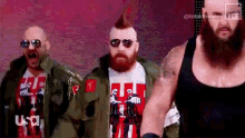 a group of wrestlers are standing next to each other on a stage .