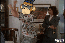 a gif of a man wearing sunglasses and a monkey with a crown