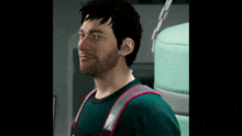 a man with a beard is wearing a green shirt with a pink strap