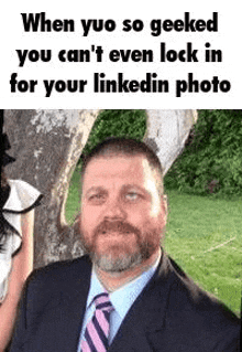 a man in a suit and tie is looking at the camera .