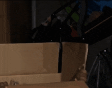 a little girl is looking out of a cardboard box that says 24