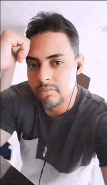 a man wearing headphones looks at the camera