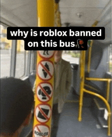 a man is riding a bus with a sign that says " why is roblox banned on this bus "