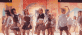 a group of girls in school uniforms are dancing on a stage