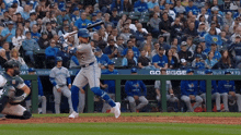 a baseball player swings his bat in front of a sign that says go bigge on it