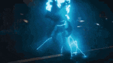 a person is standing in a dark room with a lightning bolt coming from the ceiling .