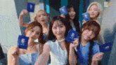 a group of girls are posing for a photo while holding passports with the letter c on them