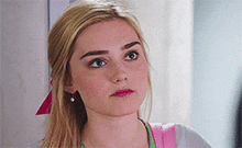 a close up of a woman 's face with a serious look on her face