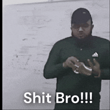 a man with a beard is standing in front of a white board and says shit bro !!