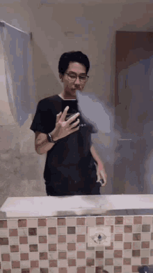 a man taking a picture of himself in a bathroom mirror with smoke coming out of his mouth
