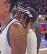 a man with dreadlocks is wearing a hat with a nike logo on it