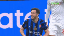 a soccer player wearing a jersey that says ' betsson ' on it