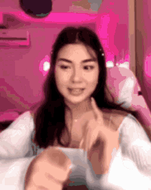a blurry picture of a woman 's face with a pink background