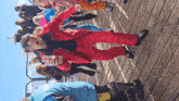 a man in a red ski suit is holding a coca cola can