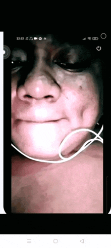 a close up of a person 's face with headphones on a cell phone screen