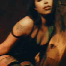 a woman with a tattoo on her arm has a triangle on her shoulder