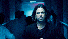 a man in a black shirt is standing in a hallway