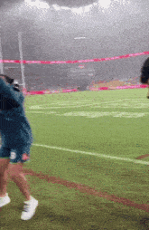 a blurry picture of a person running on a football field