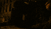 a dark room with a few lights on and a trash can