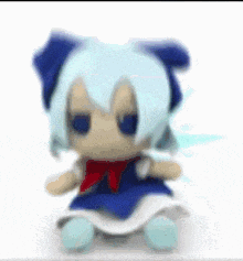 a stuffed animal with blue hair and a red bow is sitting on a white surface .