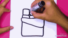 a person is drawing a picture on a piece of paper with a marker