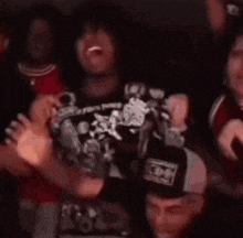 a group of people are dancing in a dark room while holding money .