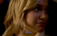a close up of a woman 's face with the words waffles written on it