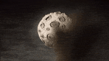 a person is standing in front of a large moon