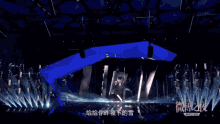 a man singing into a microphone with chinese writing on the screen
