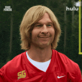 a man wearing a red nike jersey with sg on the front