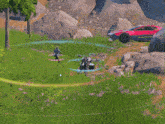 a video game scene with a red car and a tree in the background