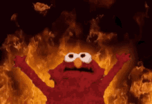 elmo from sesame street is on fire with his arms outstretched