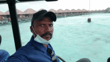 a man wearing a mask and a blue shirt that says ' rick ' on it